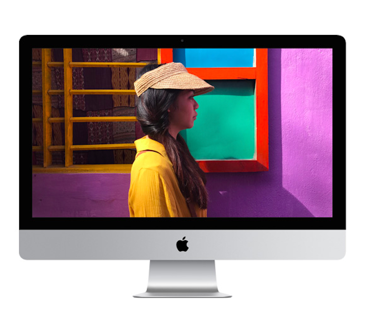 A woman wearing a hat is on the screen of an apple computer.