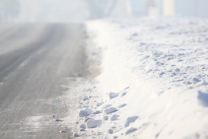 Cleaning Snow — Man Cleaning Snow with Shovel in Winter Day in Louisville, KY