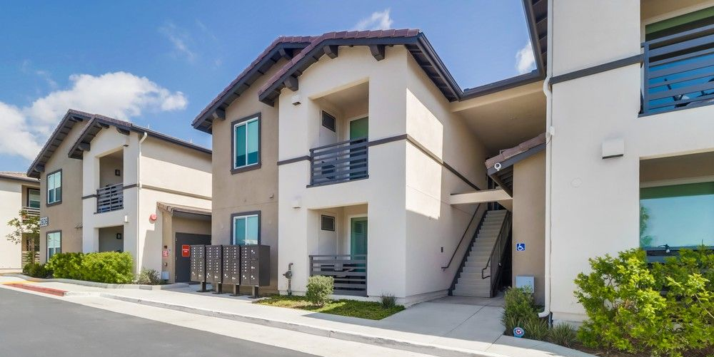 Sand dunes with parallel ridges, tan and beige tones.