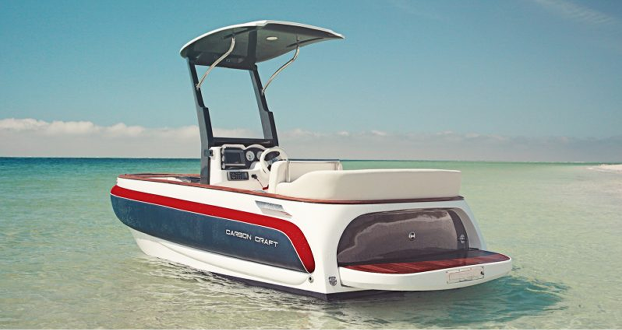 A modern, white, blue and red boat with a sunshade on a clear day in shallow water.