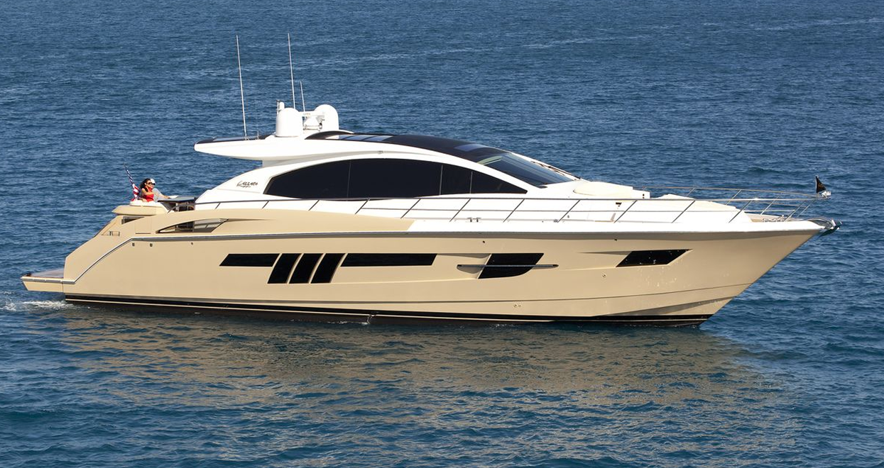 Beige and white motor yacht on blue water with black accents.