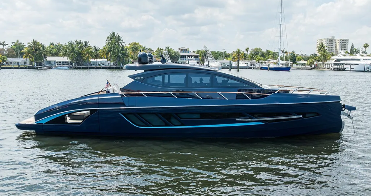 Blue luxury yacht on water, modern design, reflective windows, sunny day.
