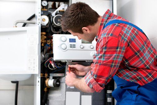 Technician servicing heating boiler — Plumbing Services in San Rafael, CA