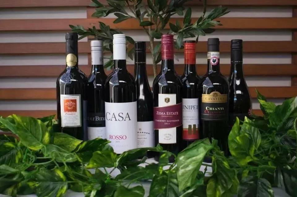 Several bottles of wine including casa are lined up on a table
