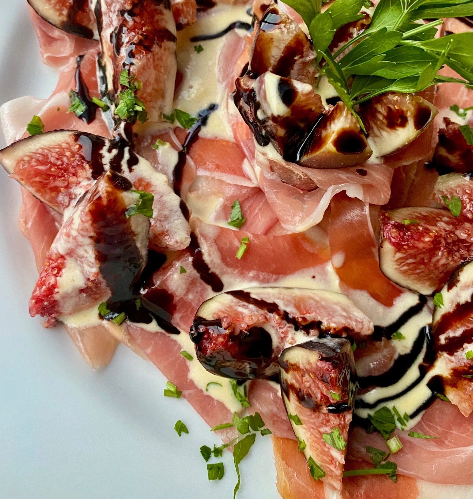 A close up of a plate of food with meat and figs