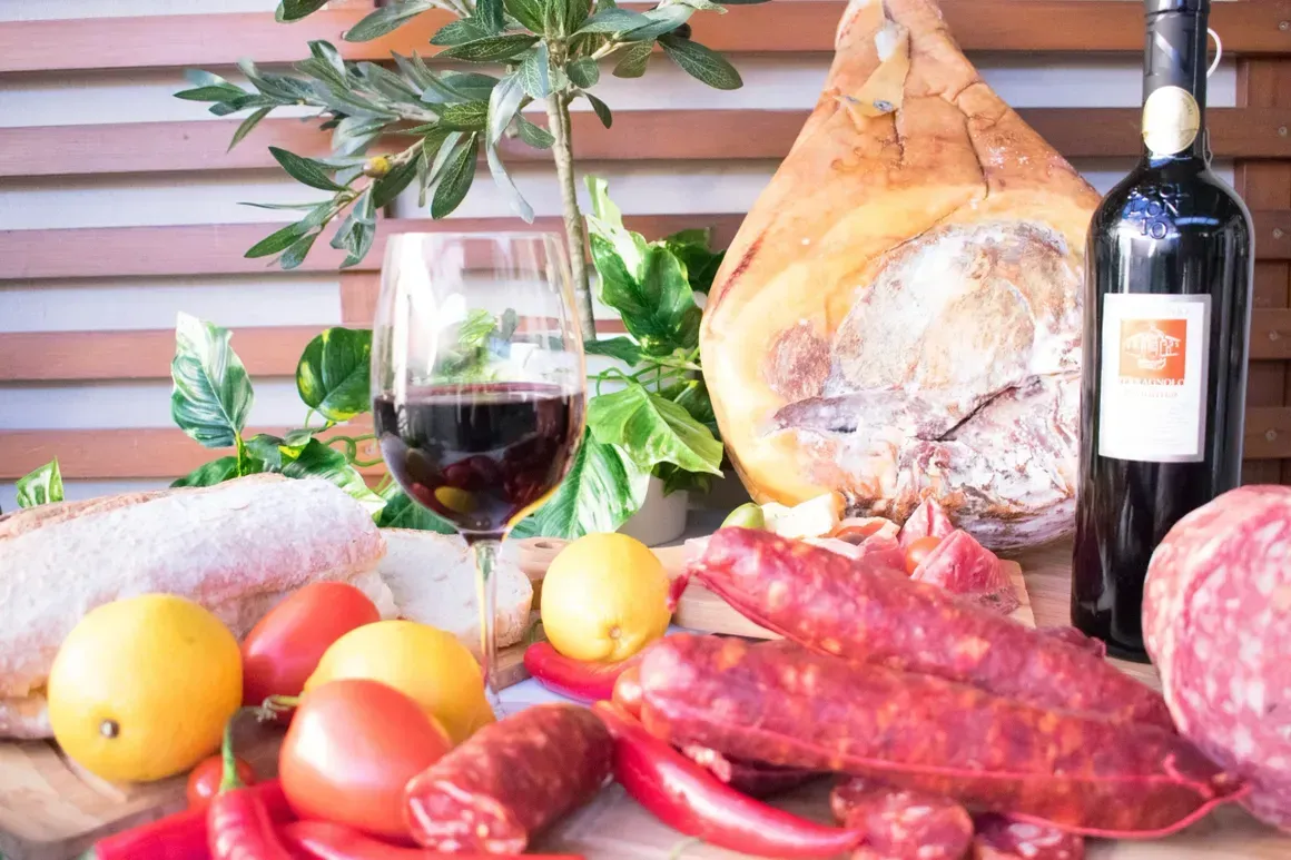 There is a bottle of wine and a glass of wine on the table.