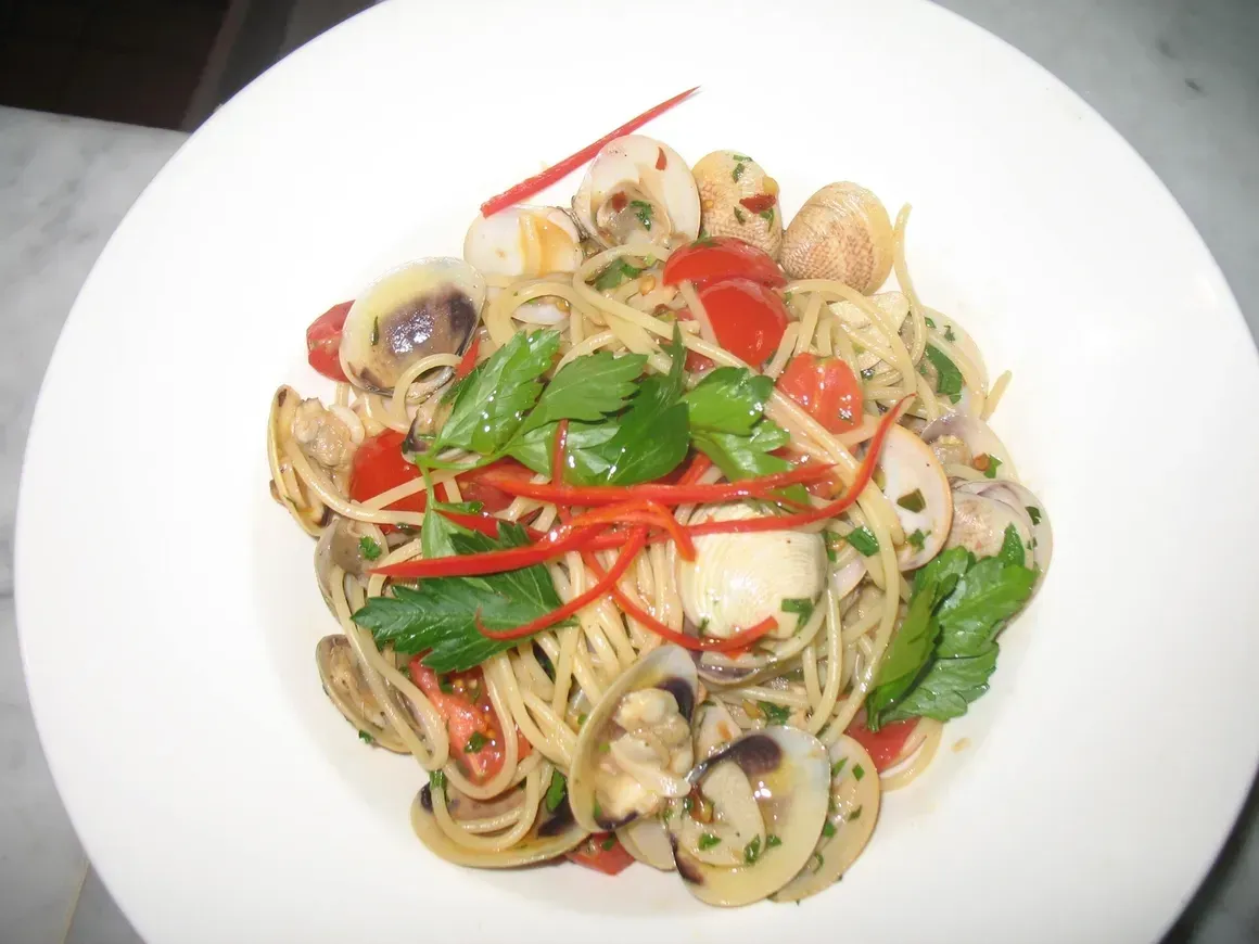 A white plate topped with noodles and vegetables
