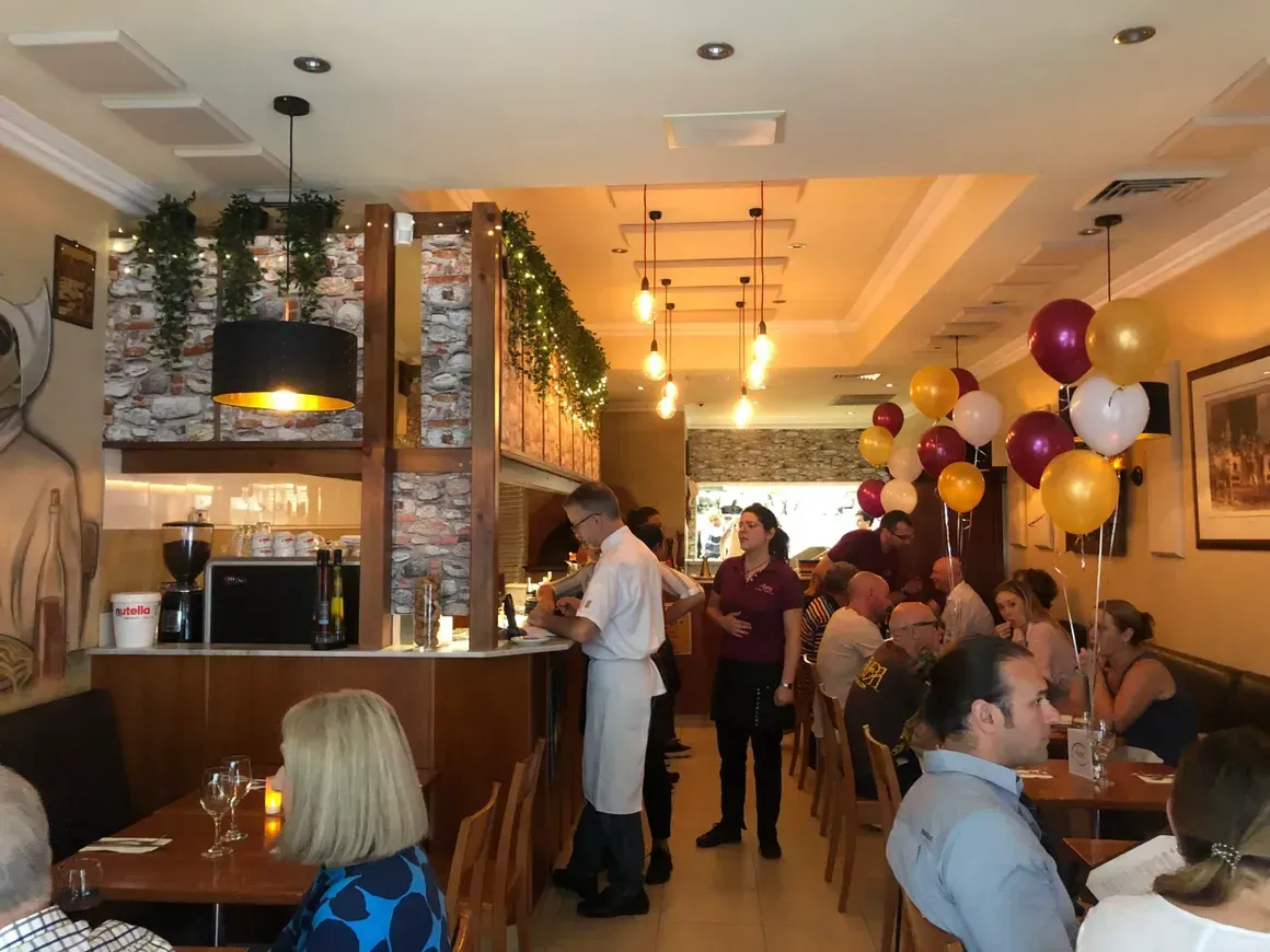 A group of people are sitting at tables in a restaurant