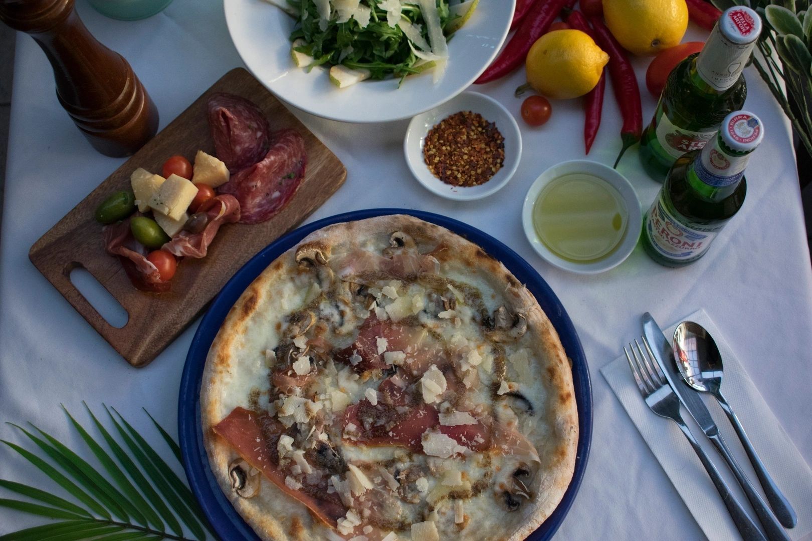 A pizza is on a blue plate on a table
