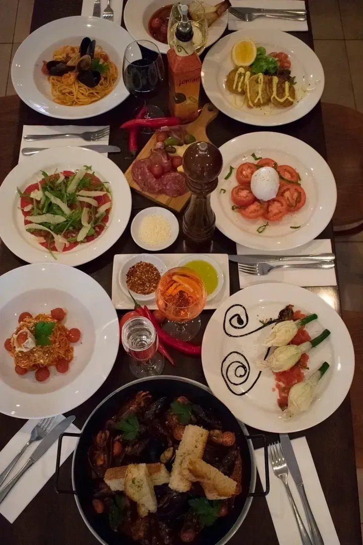 A table topped with plates of food and utensils