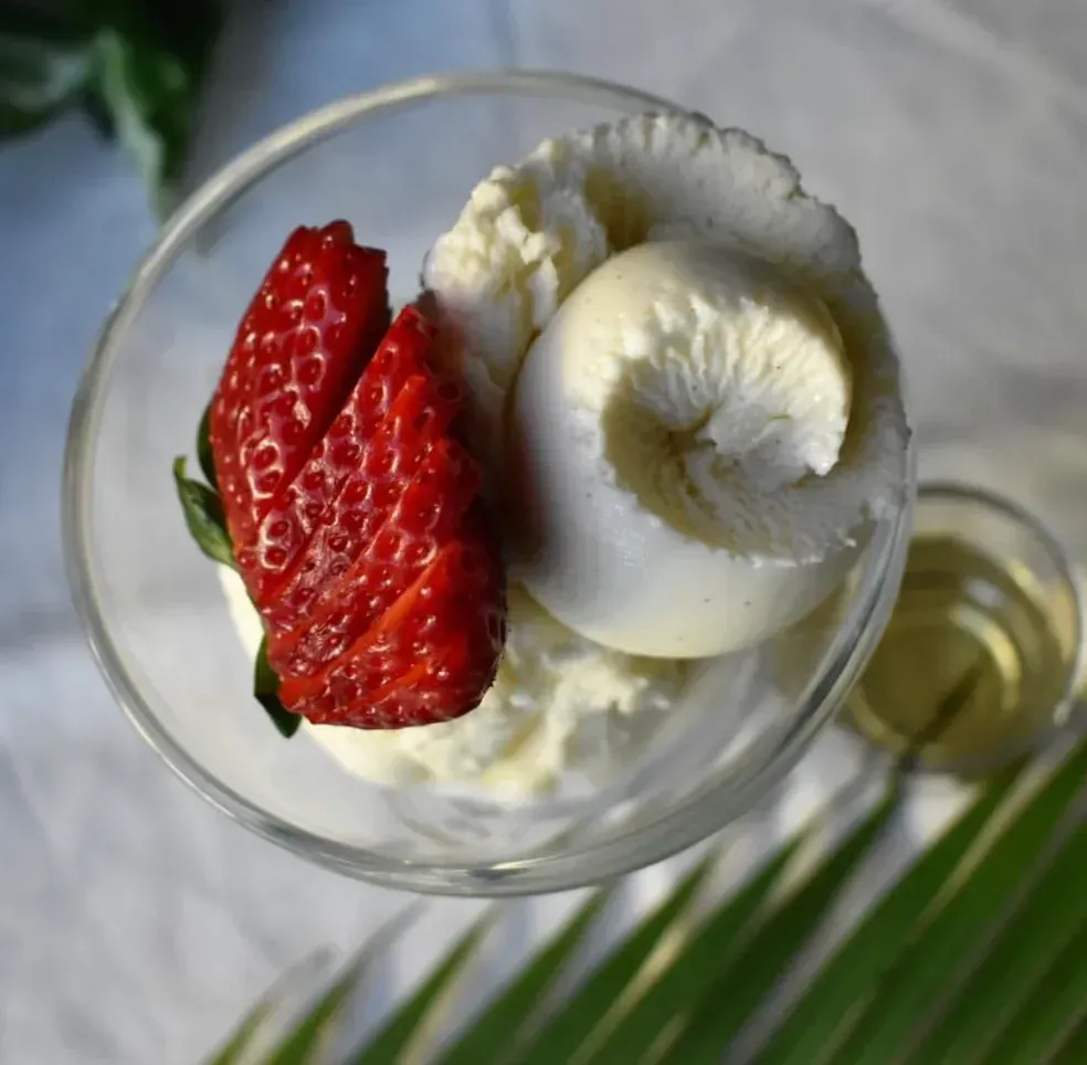 A bowl of ice cream with a strawberry on top