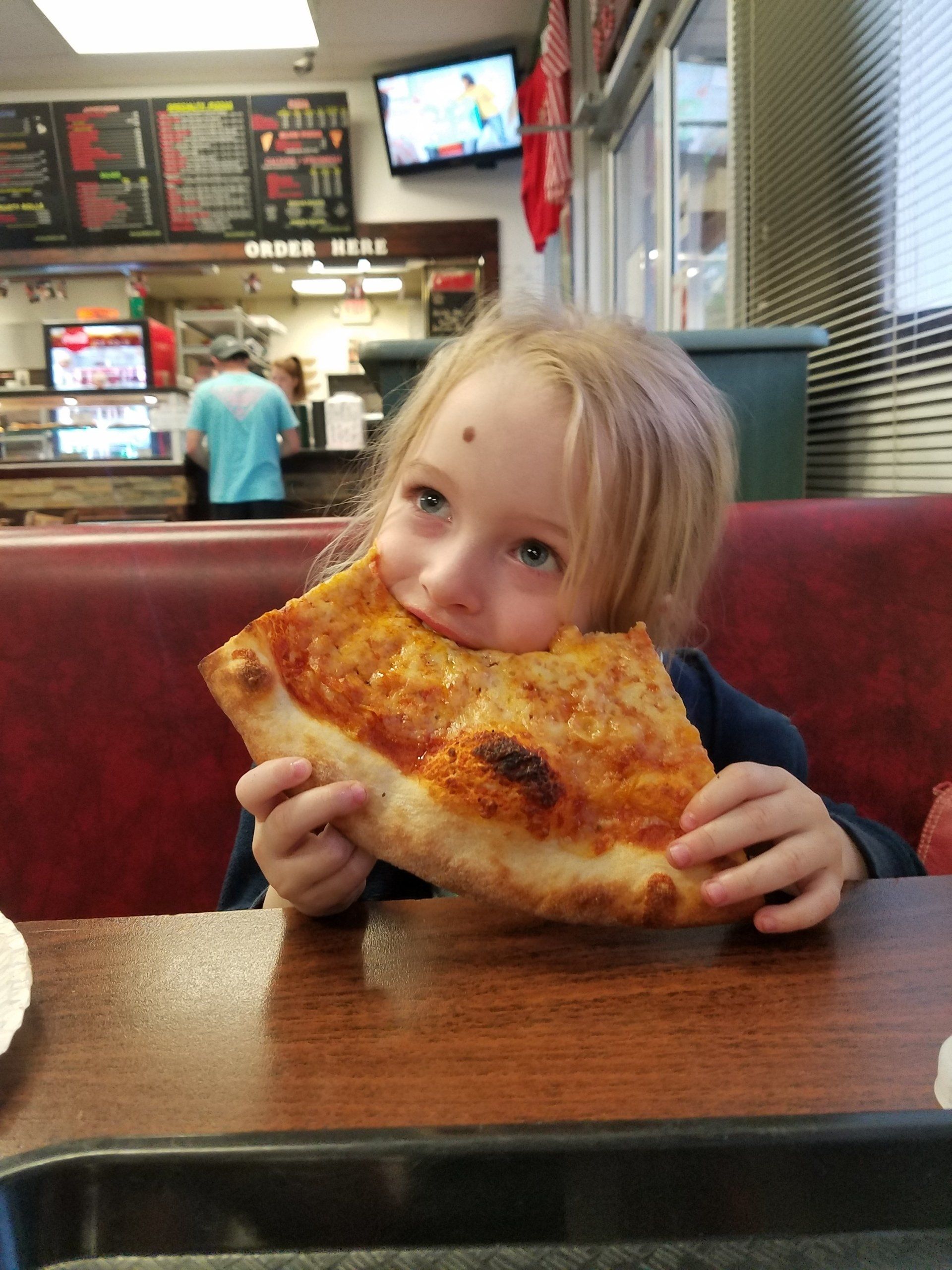 Pizza Restaurant — Baby Girl Eating Pizza in Lynchburg, VA
