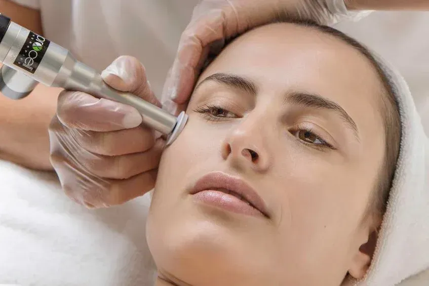 A woman is getting a facial treatment at a spa.