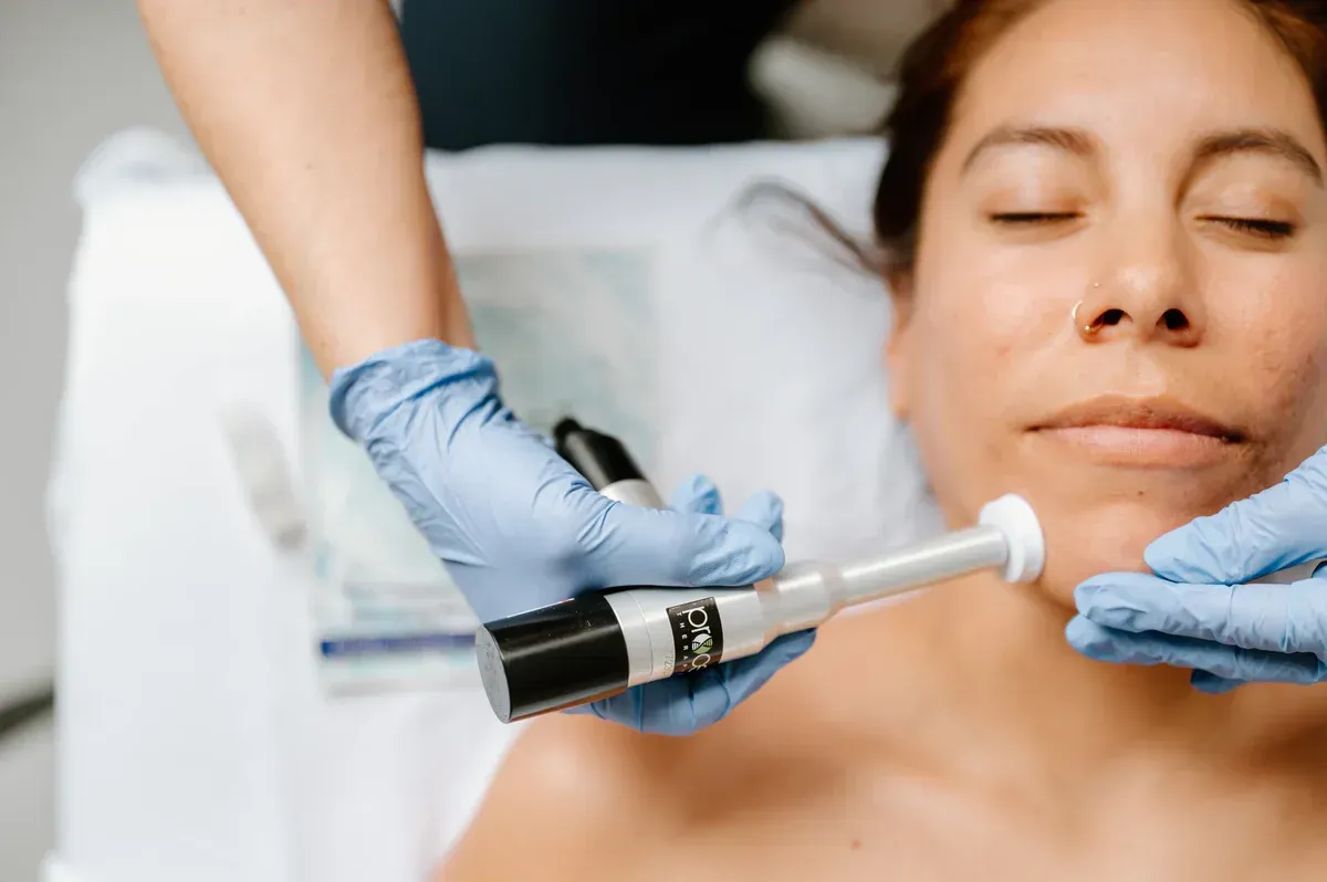 A woman is getting a facial treatment at a beauty salon.