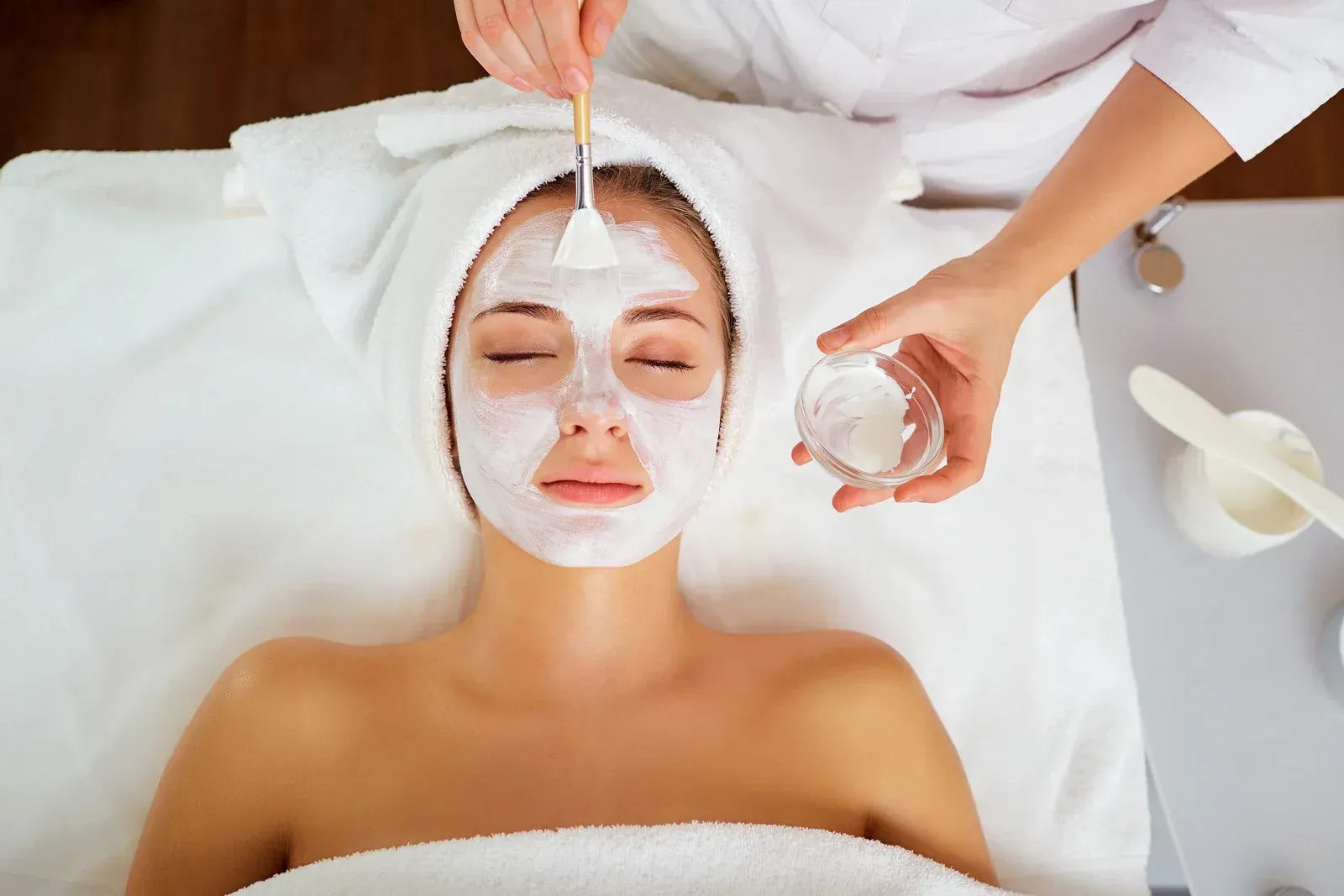 A woman is getting a facial treatment at a spa.
