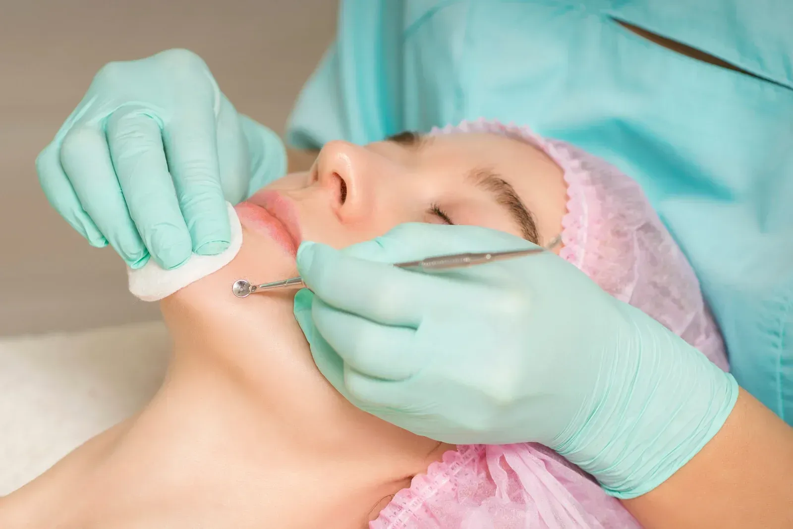 A woman is getting a facial treatment at a beauty salon.