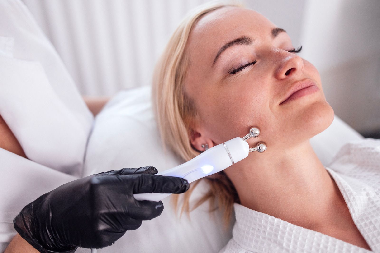 A woman is getting a facial treatment at a beauty salon.