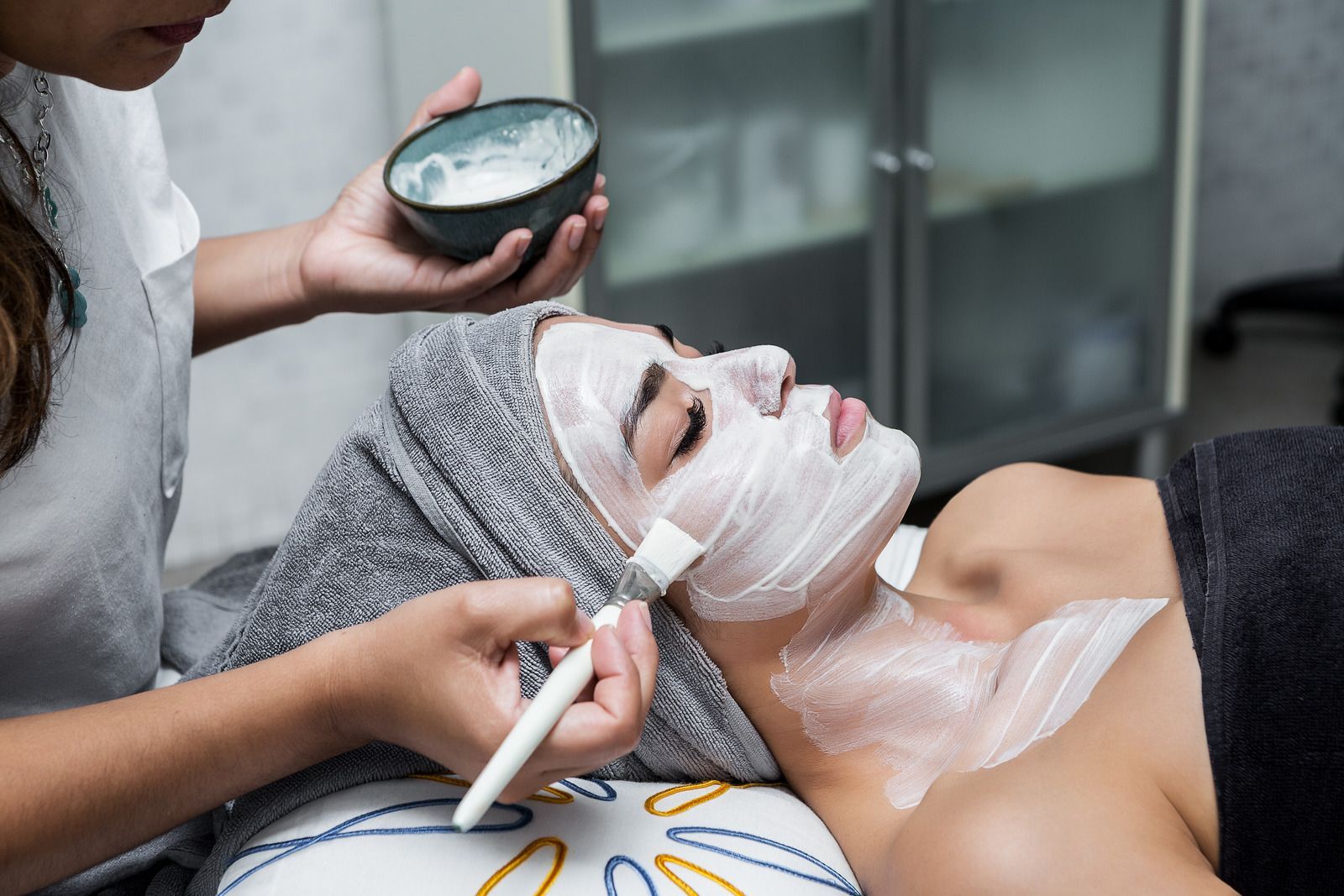 A woman is getting a facial treatment at a spa.