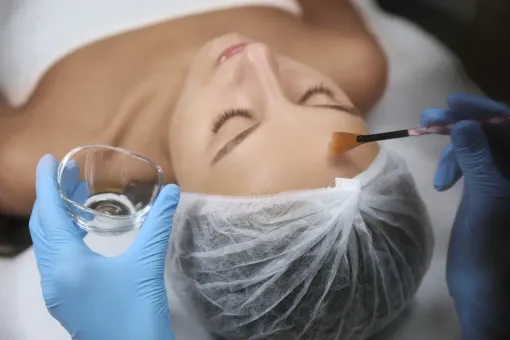 A woman is getting a facial treatment at a spa.