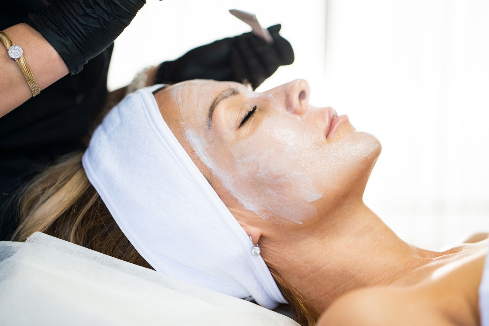 A woman is getting a facial treatment at a spa.