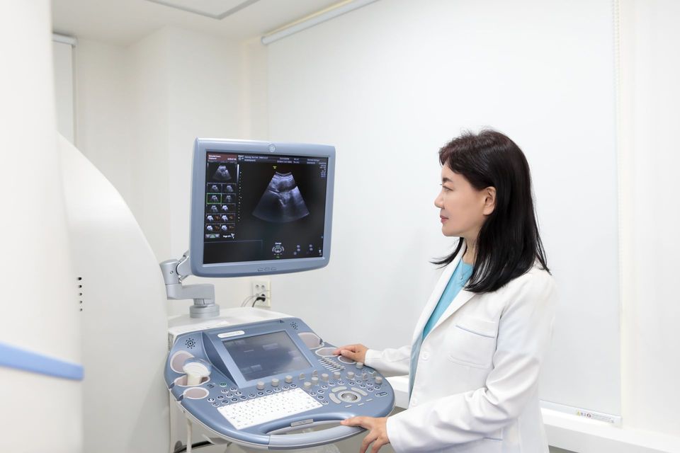 Female OB-GYN at her desk beside an ultrasound machine, Sinsoe Women's Clinic Seoul