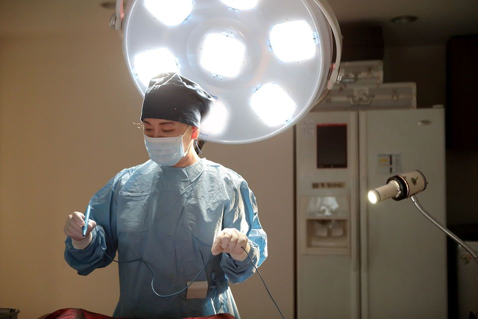 Female chief surgeon wearing a surgical cap in the operating room at Sinsoe Women's Clinic, Gangnam, Seoul