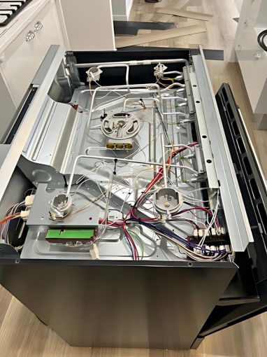 A Stainless Steel Gas Stove Has it's Wiring Exposed — FC Gas Fitting in Maryborough, QLD