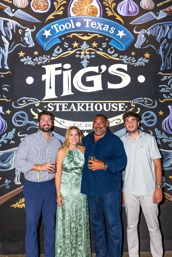 Four people stand in front of