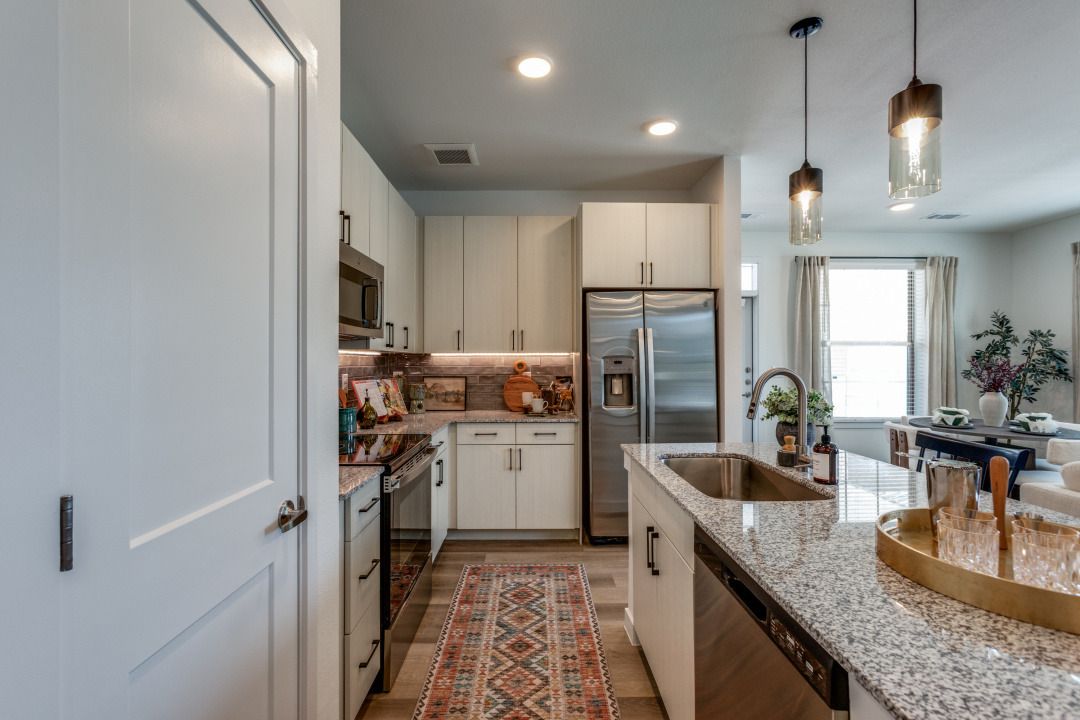 A kitchen with stainless steel appliances and granite counter tops.