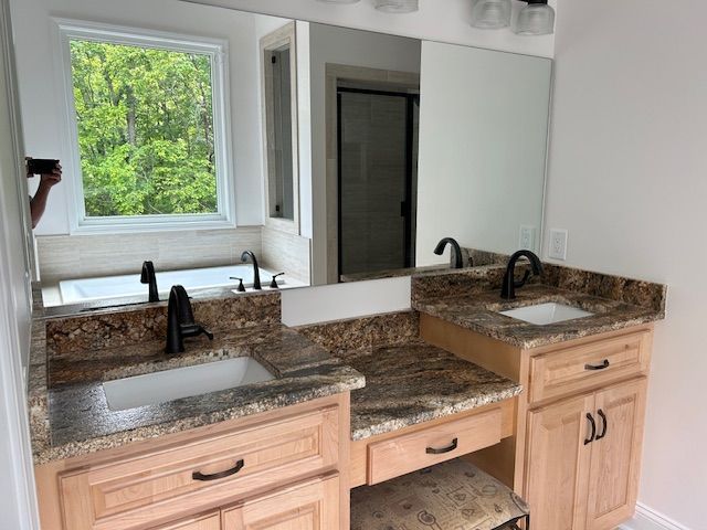 A bathroom with two sinks and a large mirror.