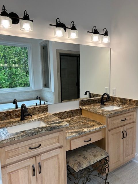 A bathroom with two sinks and a large mirror
