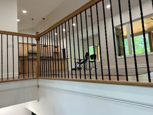 A staircase with a black railing in a house