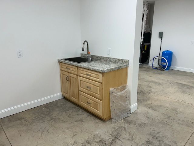 There is a sink in the middle of the room.