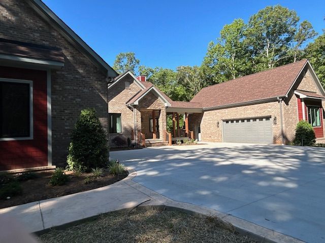 A brick house with a garage and a driveway