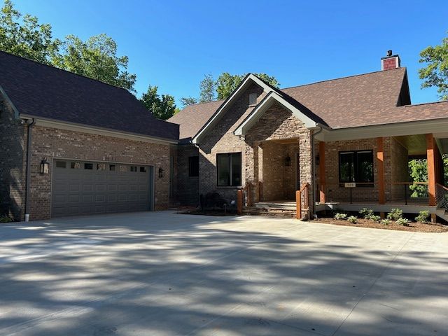 A large brick house with a garage and porch