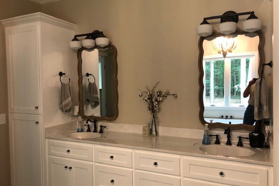 A bathroom with two sinks and two mirrors.