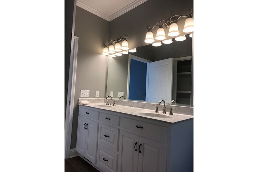 A bathroom with two sinks and a large mirror.