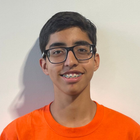 Young man with braces and glasses smiles, wearing an orange shirt against a white background.