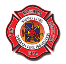 Utah Fire Marshals Association logo: red Maltese cross with central badge displaying fire tools and text.