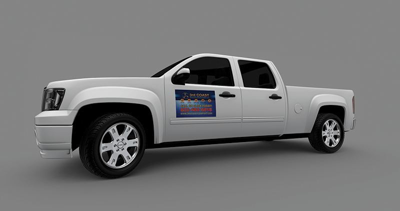 White pickup truck with a magnetic sign on the door against a gray backdrop.