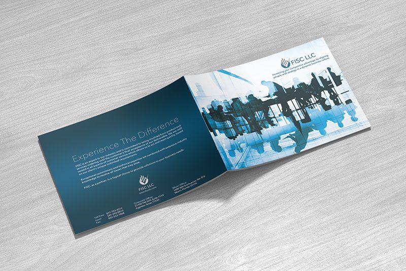 Brochure open on a wood surface with a blue and white color scheme. Text and a world map graphic are visible.