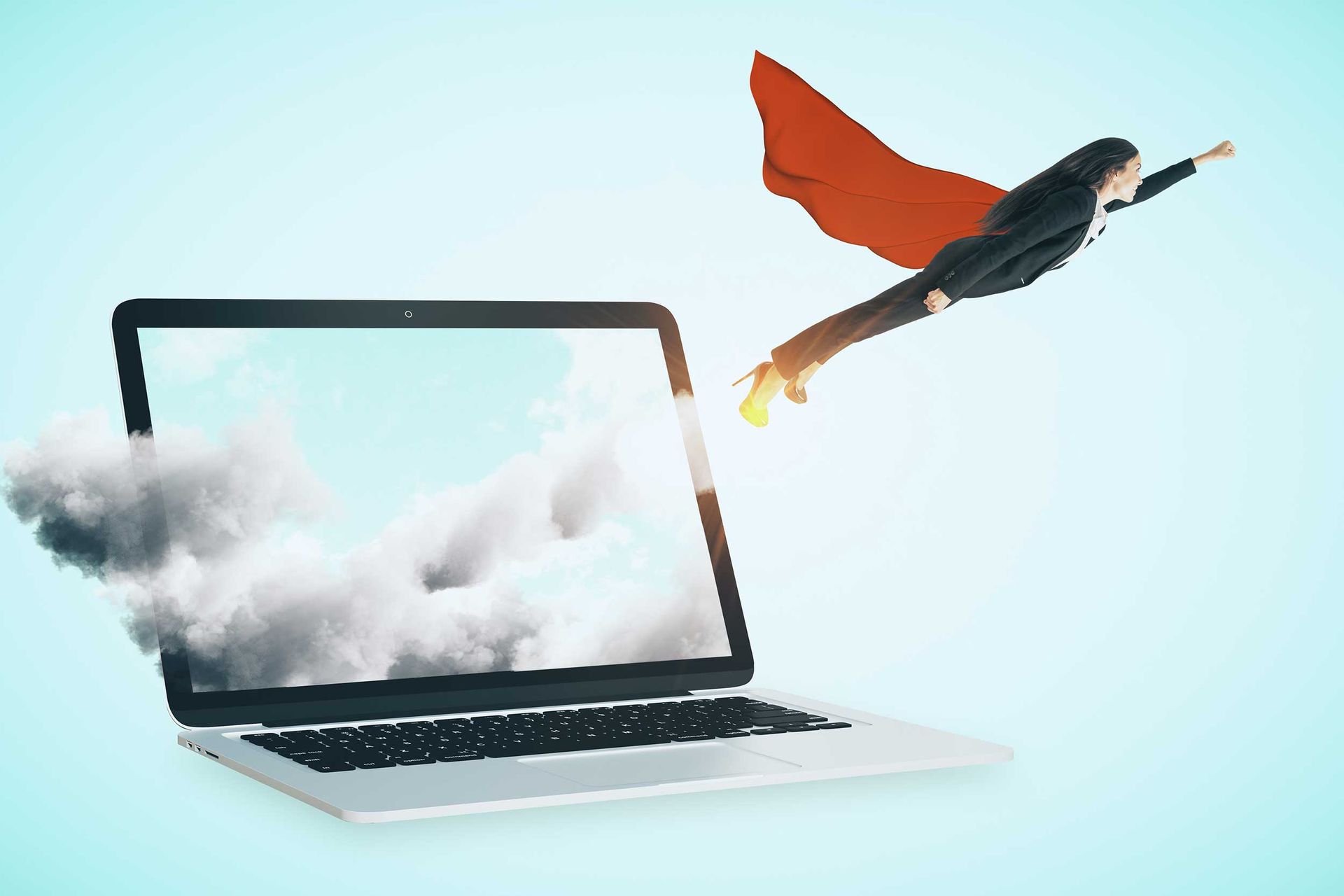 Photo of a woman wearing a cape flying out of a laptop