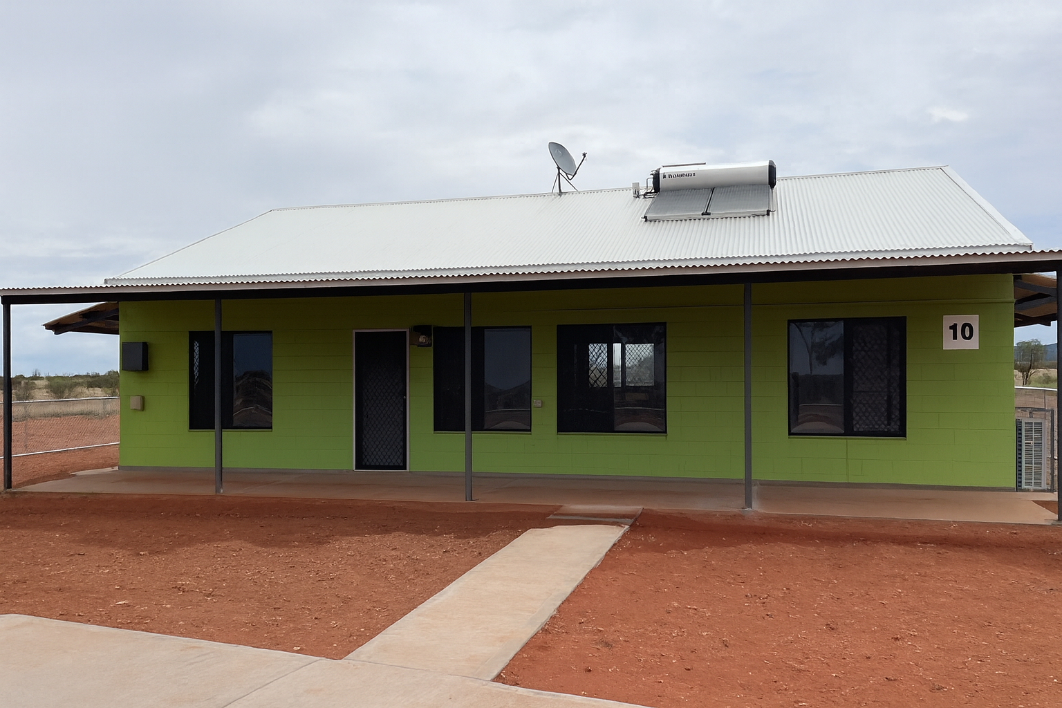 Green house with a solar panel and satellite dish on the roof — Pedersen NT Pty Ltd in Ciccone, NT