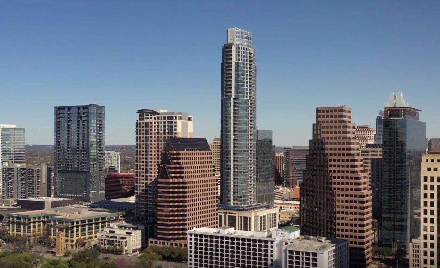 An aerial view of a city skyline on a sunny day.