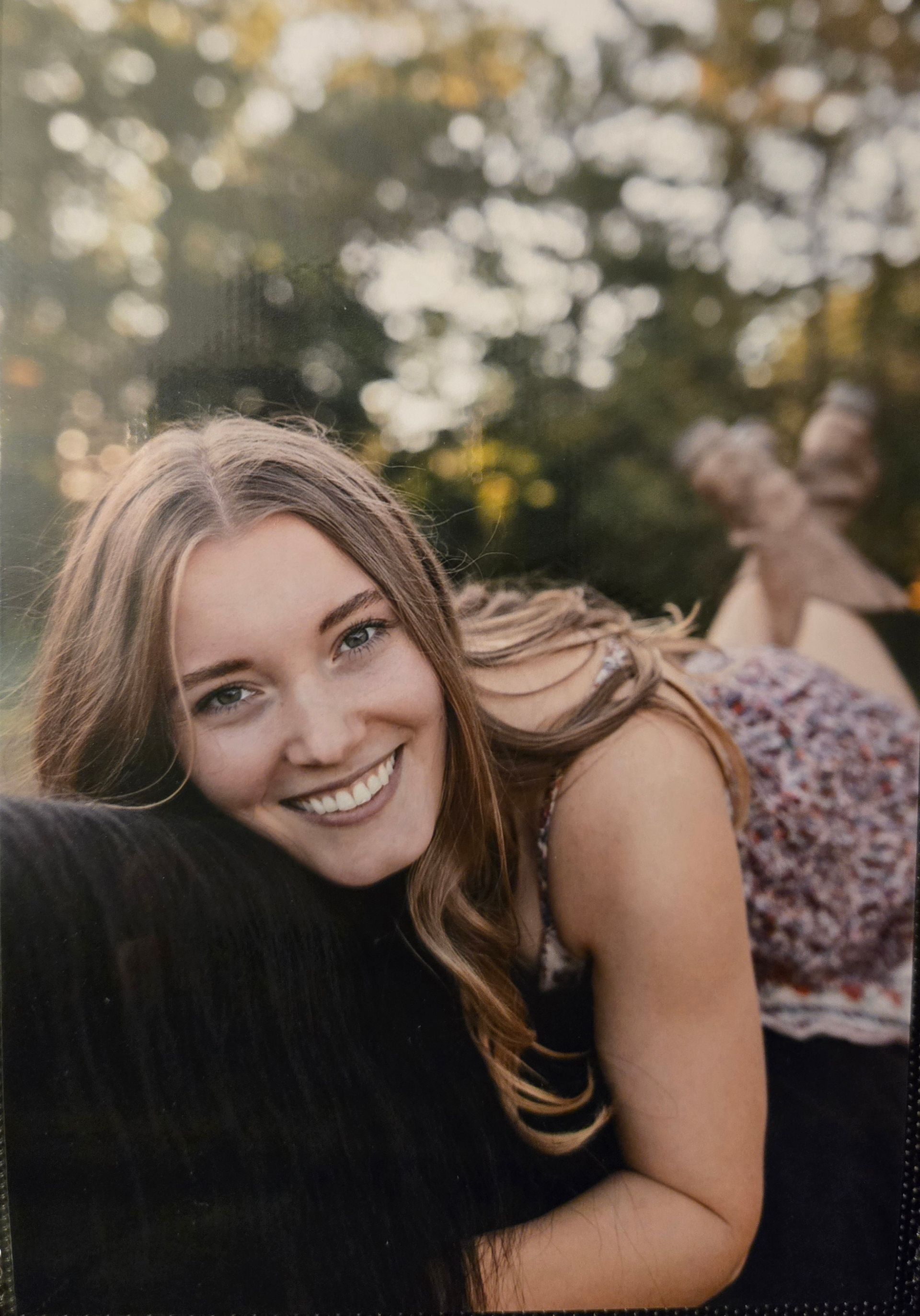 A shelf filled with a variety of fruits and vegetables wrapped in plastic.