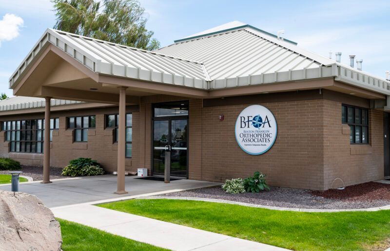 A brick building with a metal roof and a sign that says BFOA on it A brick building with a metal roof and a sign that says BFOA on it
