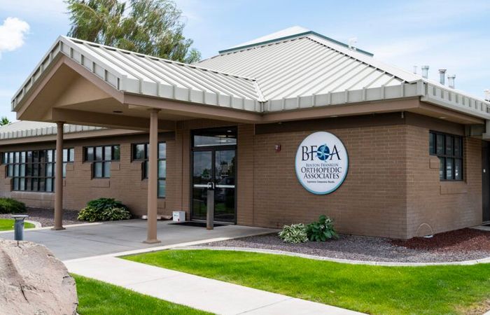 A brick building with a metal roof and a sign that says BFOA on it A brick building with a metal roof and a sign that says BFOA on it