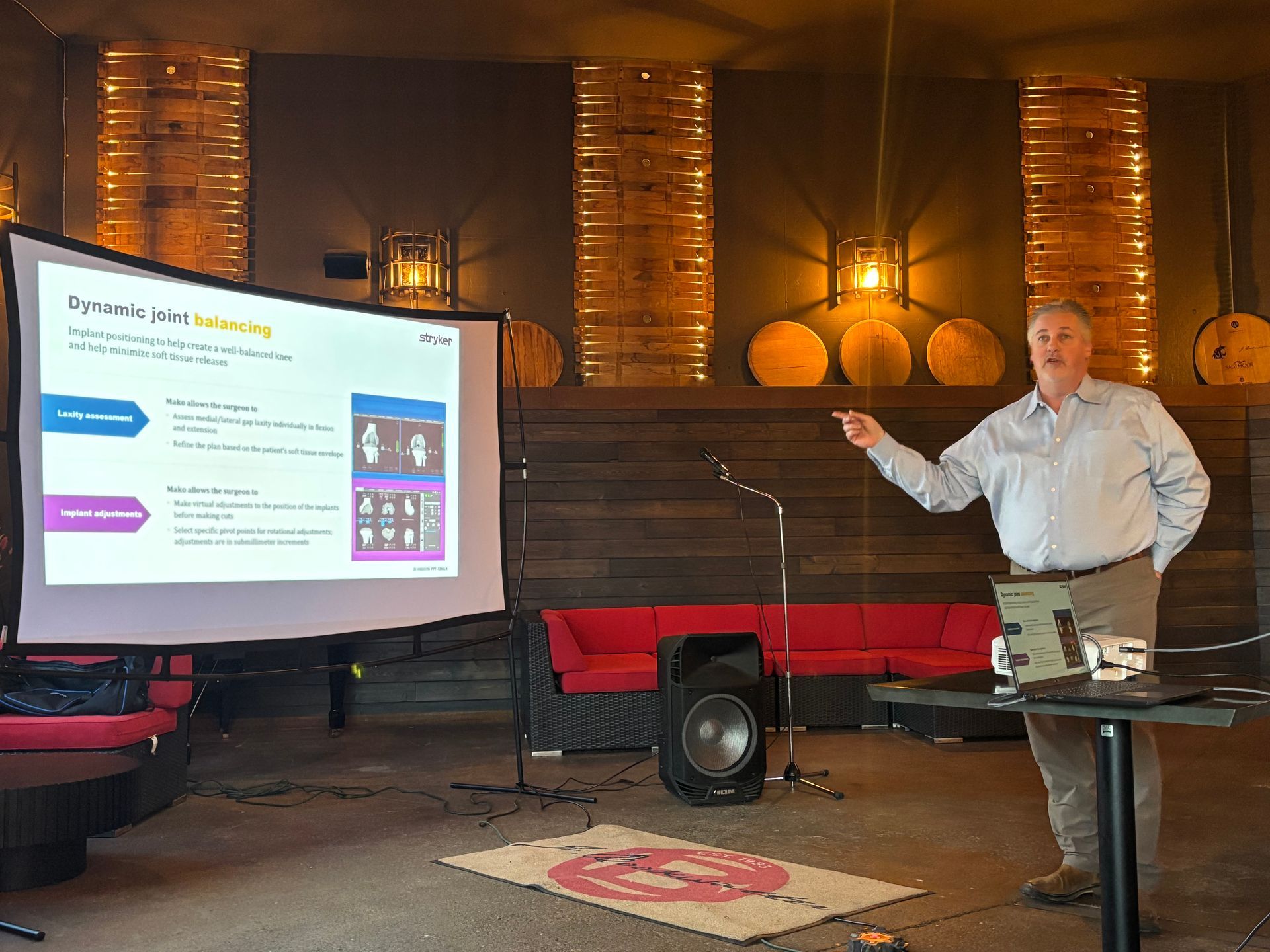 Man presenting a slideshow in a dimly lit room; pointing to the screen. Man presenting a slideshow in a dimly lit room; pointing to the screen.
