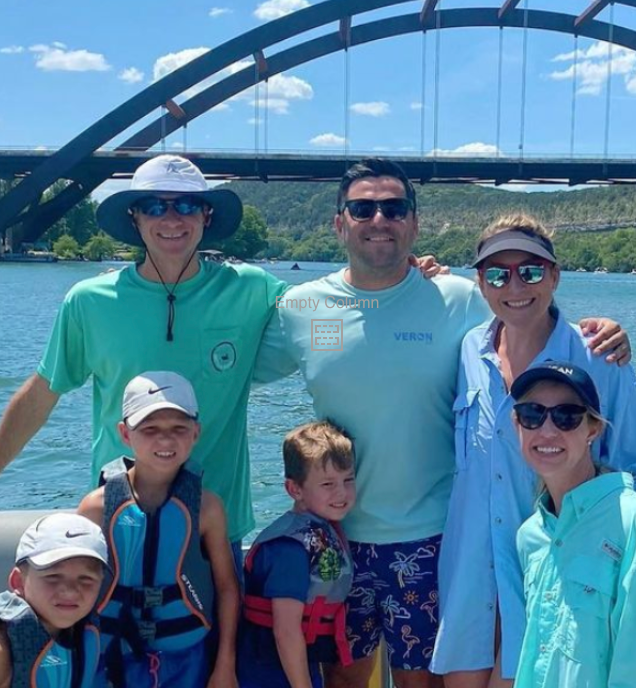 A group of people posing for a picture in front of a bridge