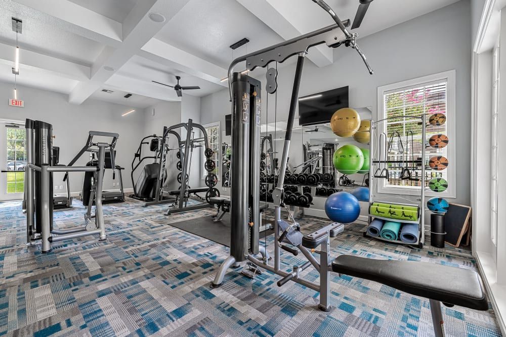 The fitness center is filled with lots of exercise equipment and a bench at Marquis at Silver Oaks in Grapevine, TX.